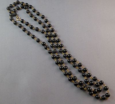 Black glass beads on gold-tone wires
Long
