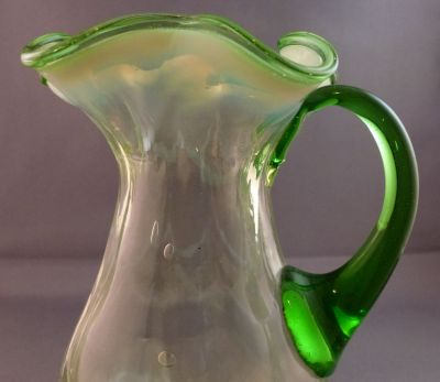 Opalescent drape and rib jug
Vertical ribs with opalescent drape. Small water jug?
Keywords: table