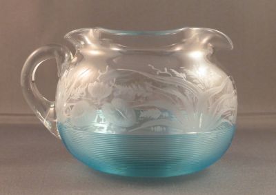 Threaded and engraved creamer
Engraved with water lilies and other water plants. Some of the engraving has been polished to give depth
Keywords: blown;british;table