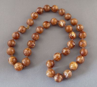 Celluloid "amber"
Vintage. Knotted
