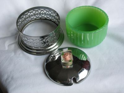 Jade glass preserve jar
Chrome holder; lucite knob; 1950s?
Keywords: sold;table