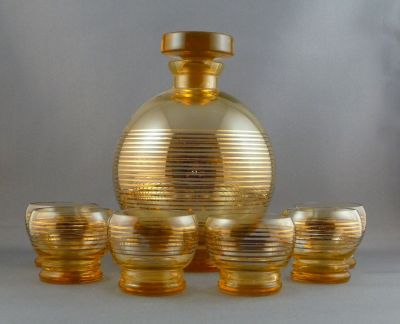Amber uranium schnapps decanter and glasses
Full set with six glasses. Gilded. Czech?
Keywords: barware;blown;czech;enamelgilt