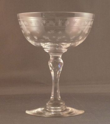 Champagne coupe, star cut with star and circle band
Cut stem with faceted knop. Lead crystal
Keywords: blown;cut;sold